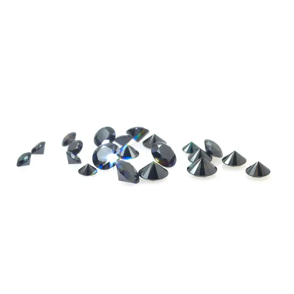 a collection of black round moissanite stones strewn across a white background