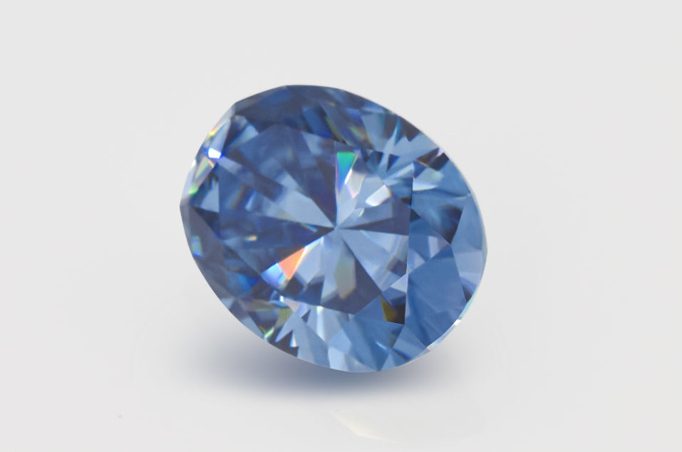 blue oval cut moissanite stone on light grey background, side view