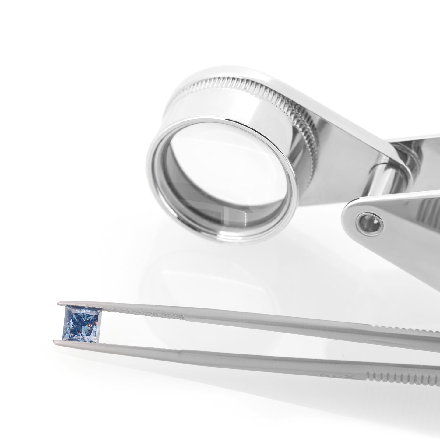 blue princess cut moissanite stone between tweezers