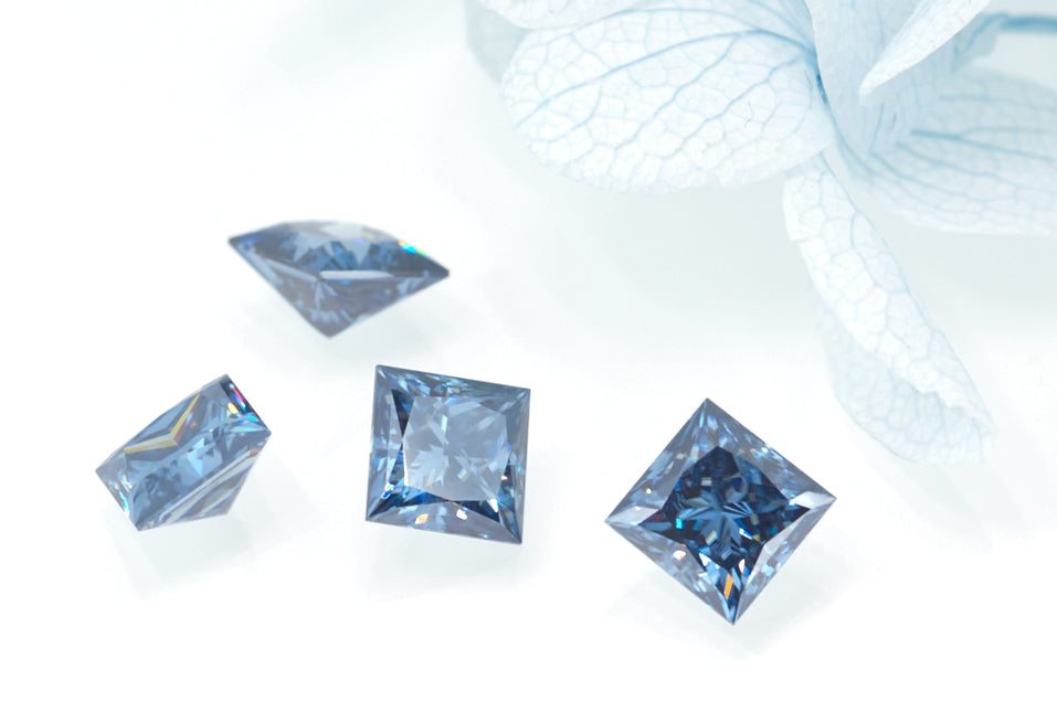 a collection of blue princess cut moissanite stones on white background