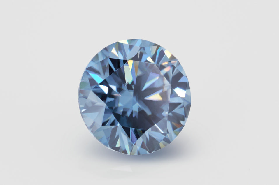 blue round cut moissanite stone on light grey background, side view