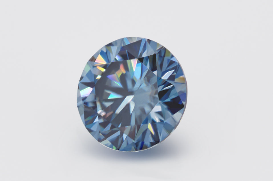 blue round cut moissanite stone on light grey background, side view