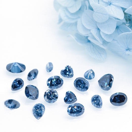 a collection of different cuts of dark blue moissanite stones on white background