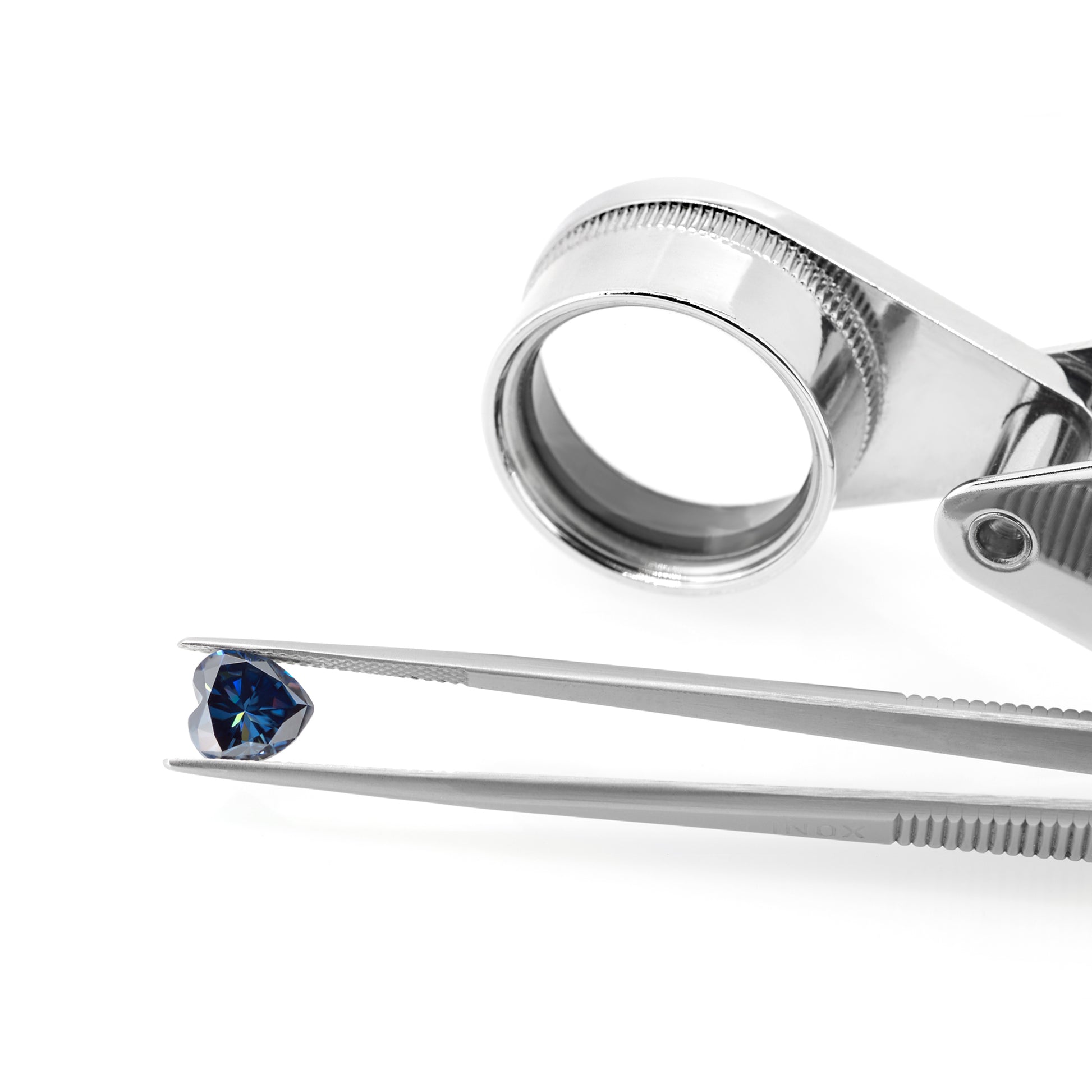 dark blue heart cut moissanite stone in tweezers on white background