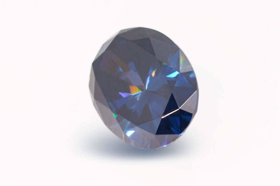 dark blue oval cut moissanite stones on white background, lying on its side