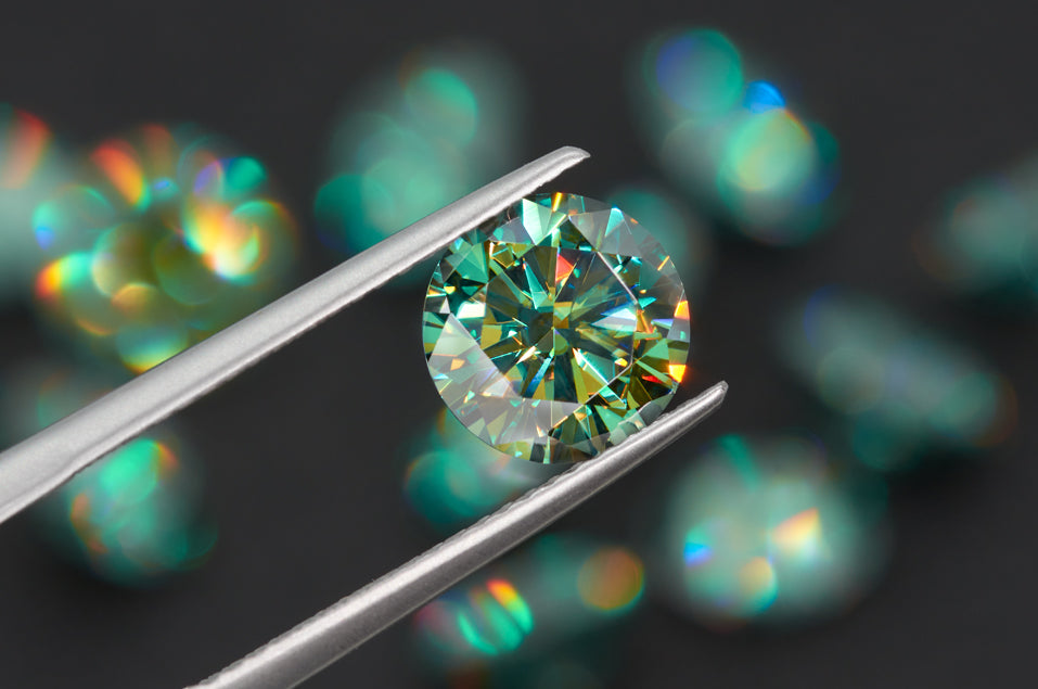 green round cut moissanite stone between tweezers, bokeh black background with other green stones