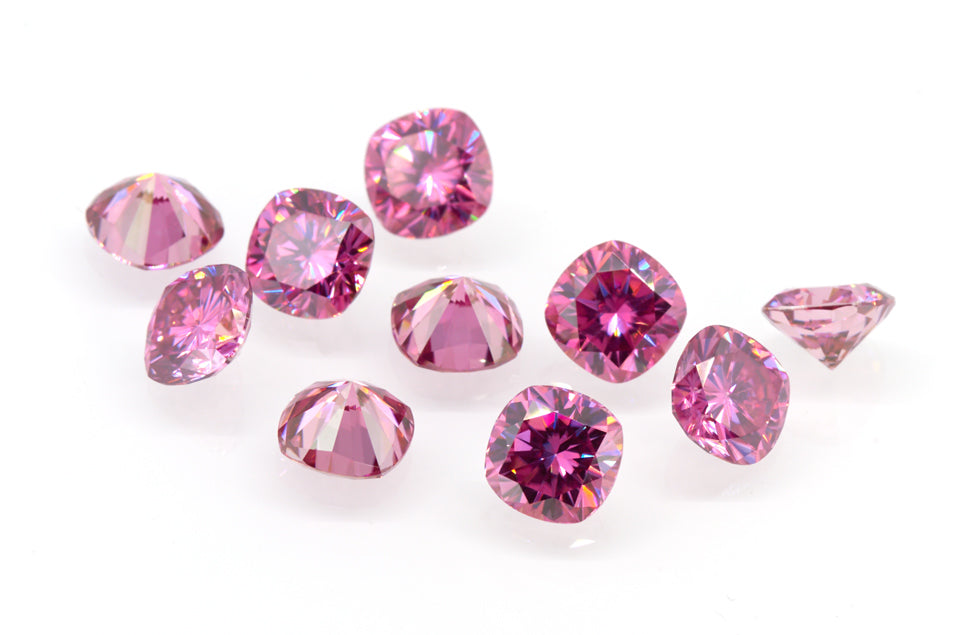 a collection of pink cushion cut moissanite stones on white background