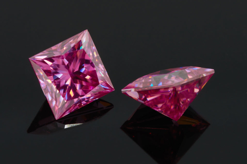 a pair of pink princess cut moissanite stones on reflective black background, top and side view