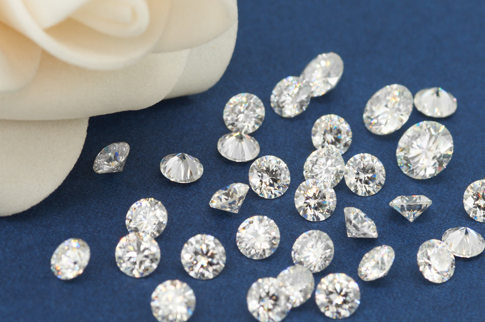 a collection of white round cut moissanite stones on soft blue