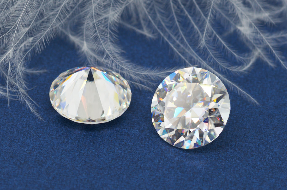 a pair of white round cut moissanite stones on soft blue background