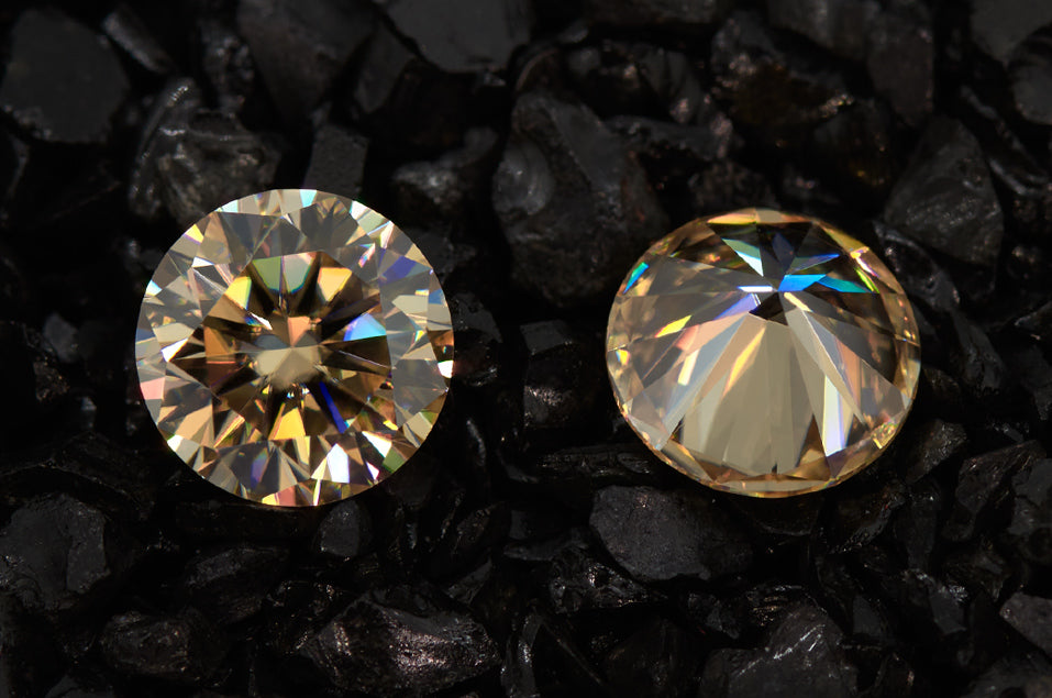 a pair of yellow round cut moissanite stones on crushed stone background